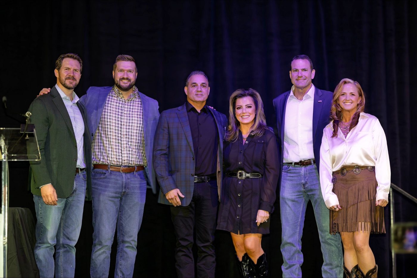 Six people standing together on stage at LEAN 2026